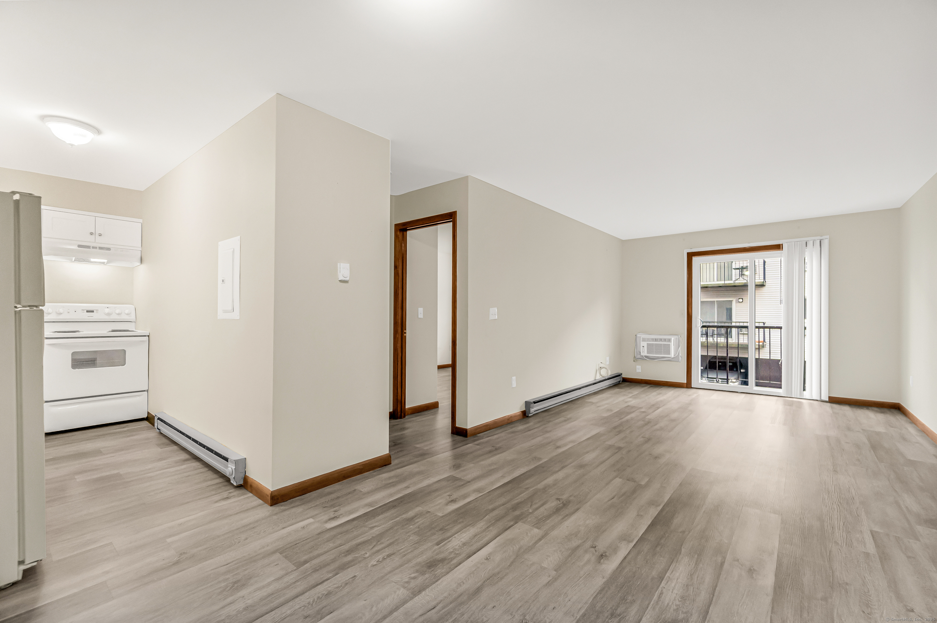 115 Short Beach Road, Unit 103 Stratford, CT 06615 - Photo 9 of 18 an empty room with wooden floor and windows