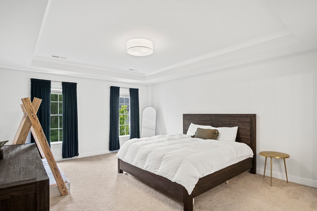 6 Sandy Pond Road Ayer, MA 01432 - Photo 21 of 37 a bedroom with a bed and a large mirror