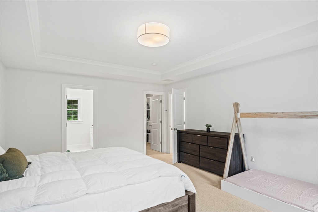 6 Sandy Pond Road Ayer, MA 01432 - Photo 22 of 37 a bedroom with a bed and a dresser