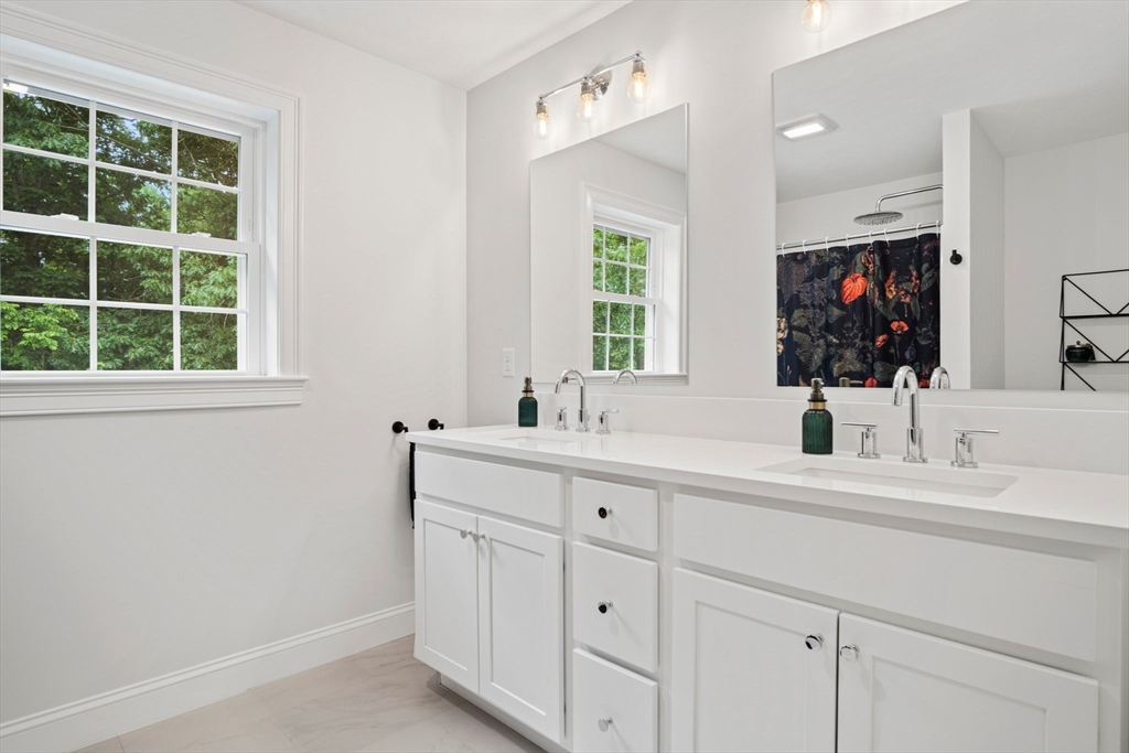 6 Sandy Pond Road Ayer, MA 01432 - Photo 23 of 37 a bathroom with a sink double vanity and a mirror