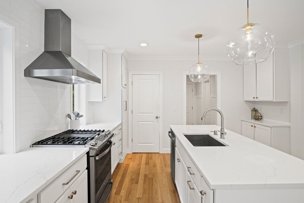 6 Sandy Pond Road Ayer, MA 01432 - Photo 7 of 37 a kitchen that has a lot of white cabinets and stainless steel appliances