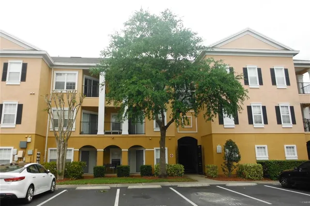 a front view of a residential apartment building with a yard