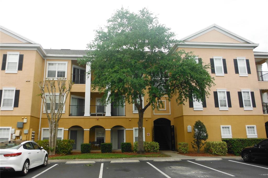 a front view of a residential apartment building with a yard