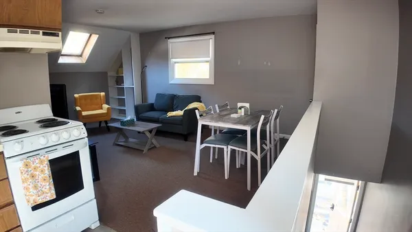 a dining room with furniture and wooden floor