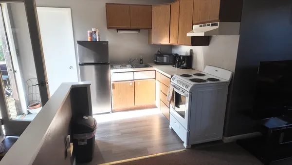 a kitchen with a sink a stove and a refrigerator