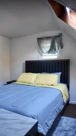 a bedroom with a bed and balcony