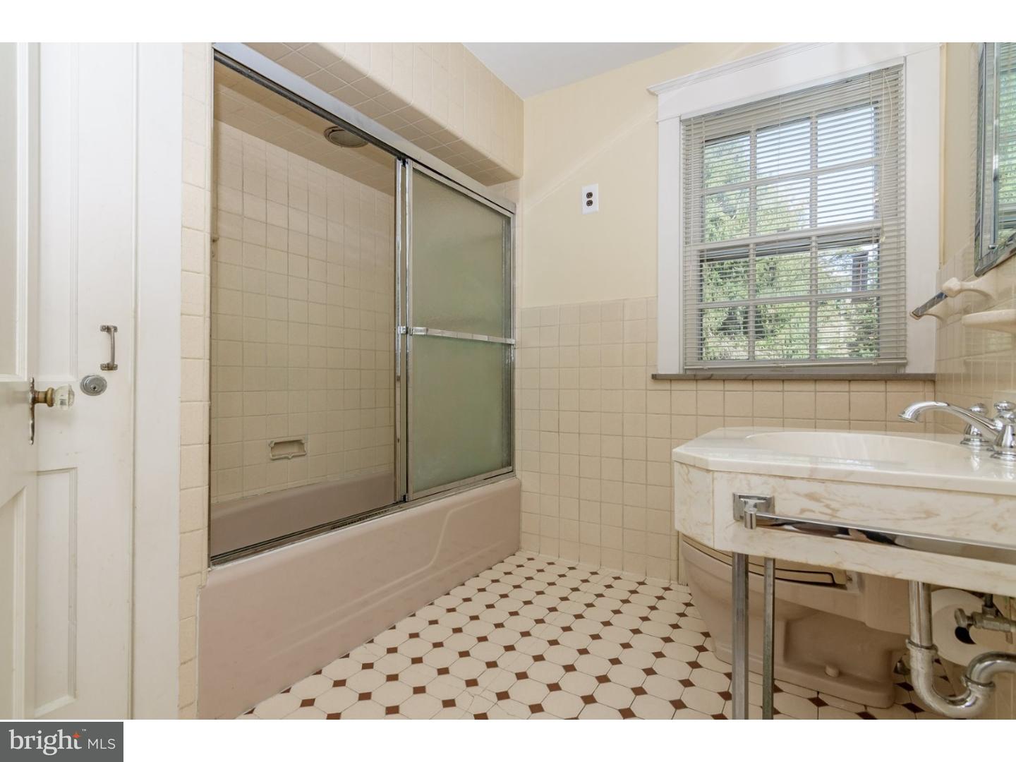 35 State Road Avondale, PA 19311 - Photo 19 of 25 a bathroom with a sink a mirror and a shower
