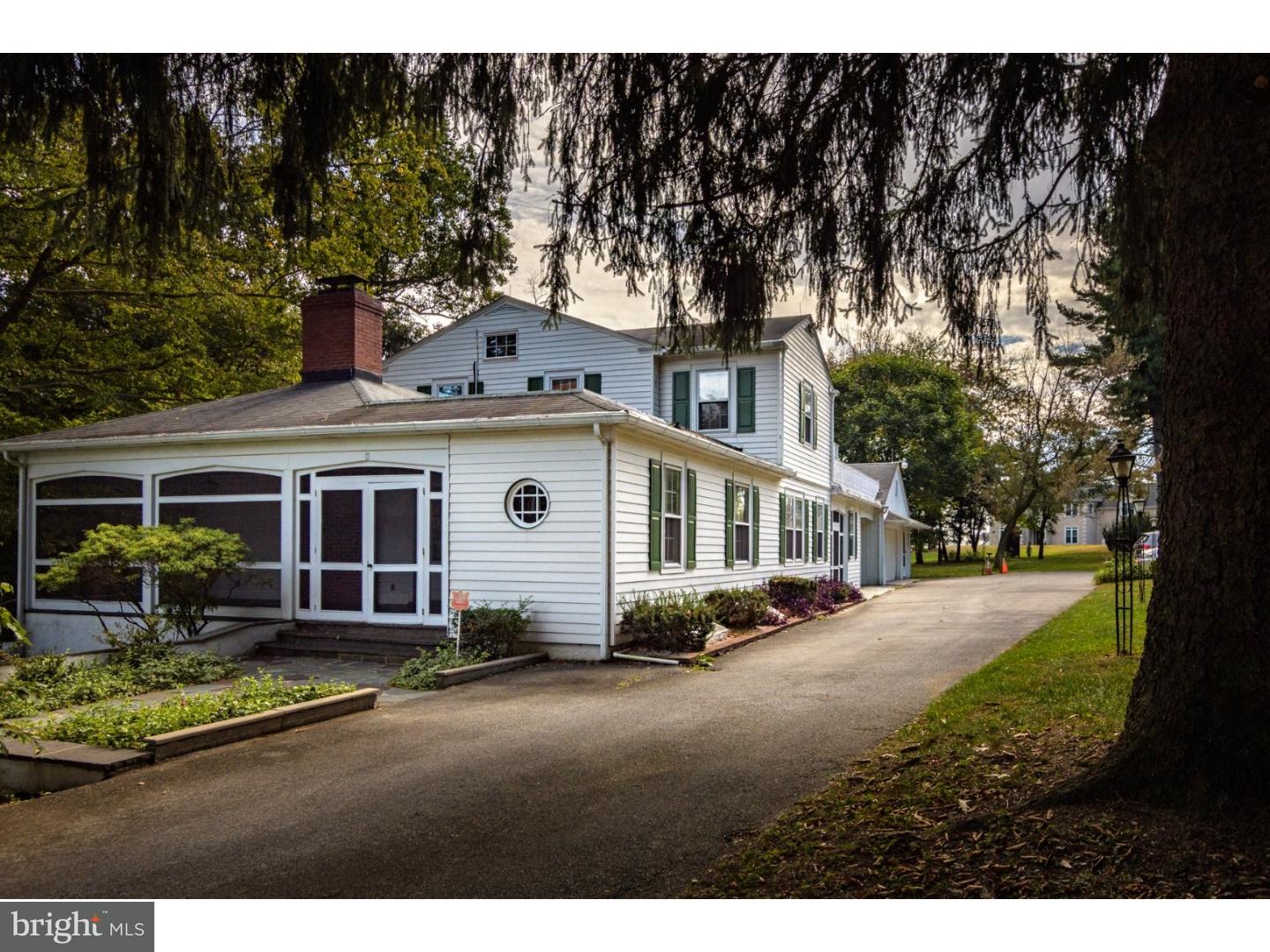 35 State Road Avondale, PA 19311 - Photo 20 of 25 a view of a white house next to a yard with potted plants