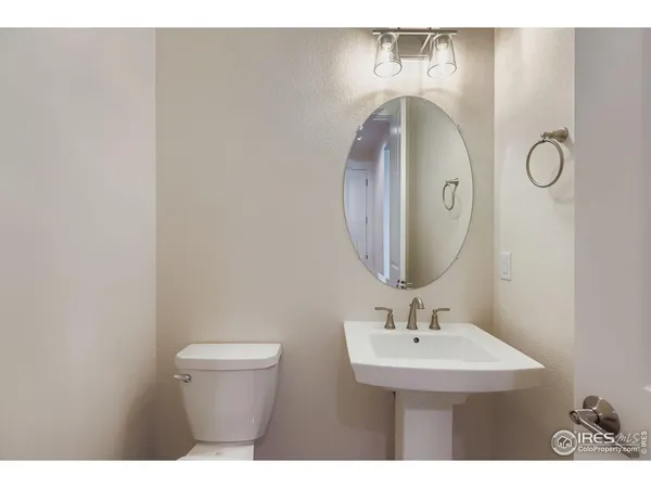 a bathroom with a sink mirror and toilet