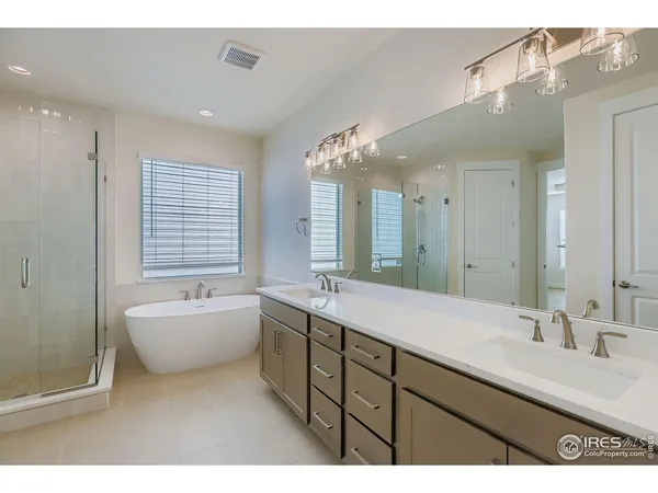 a bathroom with a sink mirror and a bathtub