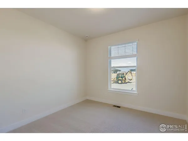 a view of an empty room and a window