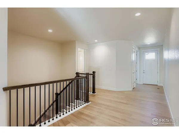 a view of hallway with wooden floor
