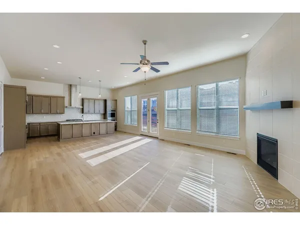 a view of a livingroom with furniture a ceiling fan and window