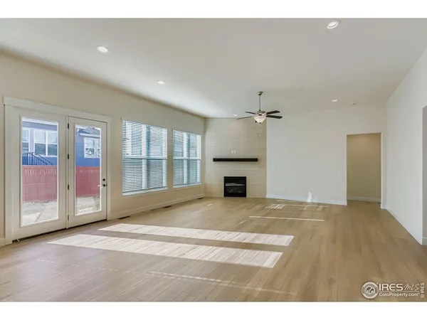 a view of an empty room with a fireplace and a window