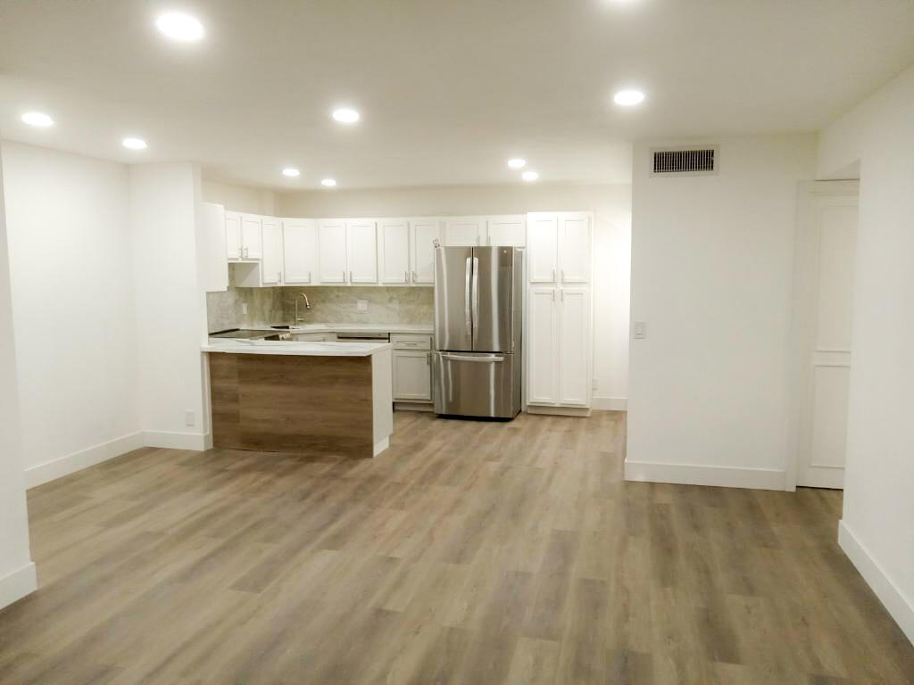 a view of kitchen empty space with wooden floor and window