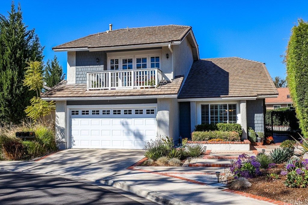 This home features wonderful curb appeal with mature drought tolerant landscape, hardscape walkway with brick accents and a private side entry.