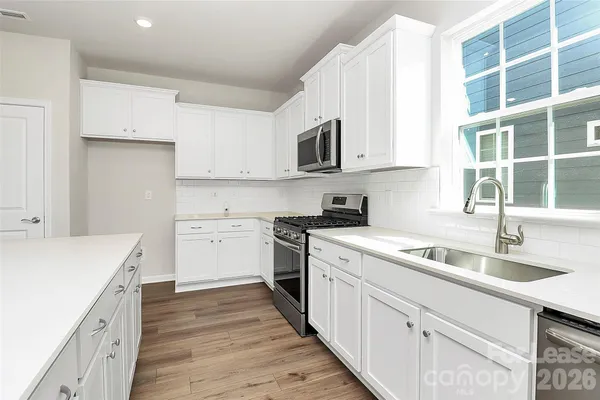 a kitchen that has a sink and a stove in it