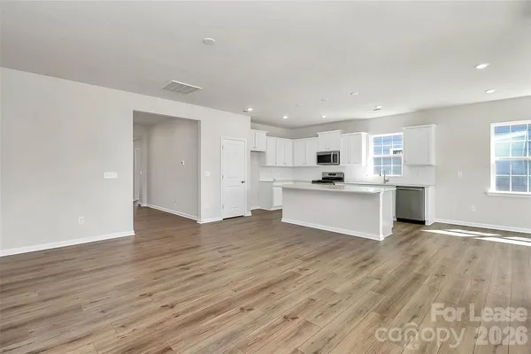 a view of kitchen with wooden floor and window