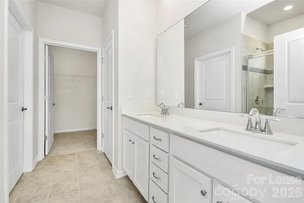 a bathroom with a double vanity sink and mirror