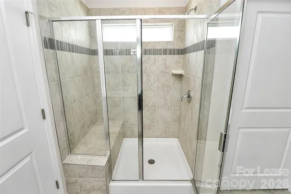 a bathroom with a glass shower door