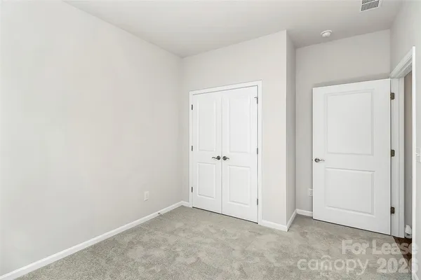 an empty room with closet area