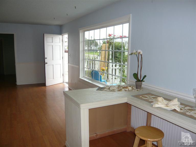 3505 Sunset Lane Oxnard, CA 93035 - Photo 4 of 21 a kitchen with a sink cabinets and wooden floor