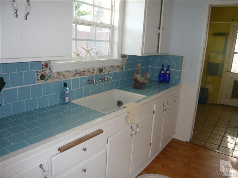 3505 Sunset Lane Oxnard, CA 93035 - Photo 6 of 21 a kitchen with a sink and cabinets