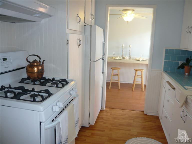 3505 Sunset Lane Oxnard, CA 93035 - Photo 7 of 21 a kitchen with a refrigerator and a stove