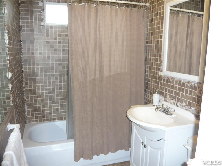 3505 Sunset Lane Oxnard, CA 93035 - Photo 10 of 21 a bathroom with a sink a bathtub and a shower