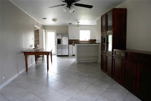 a kitchen with kitchen island a counter top space appliances and cabinets