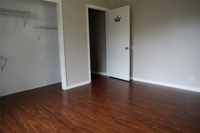 a view of a room with wooden floor