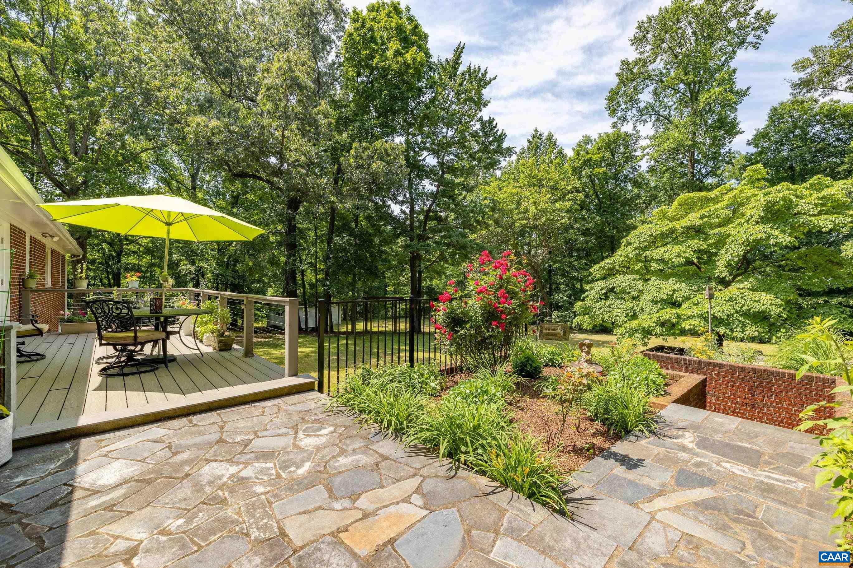 7250 Amicus Road Ruckersville, VA 22968 - Photo 14 of 74 a view of a patio with a table and chairs under an umbrella