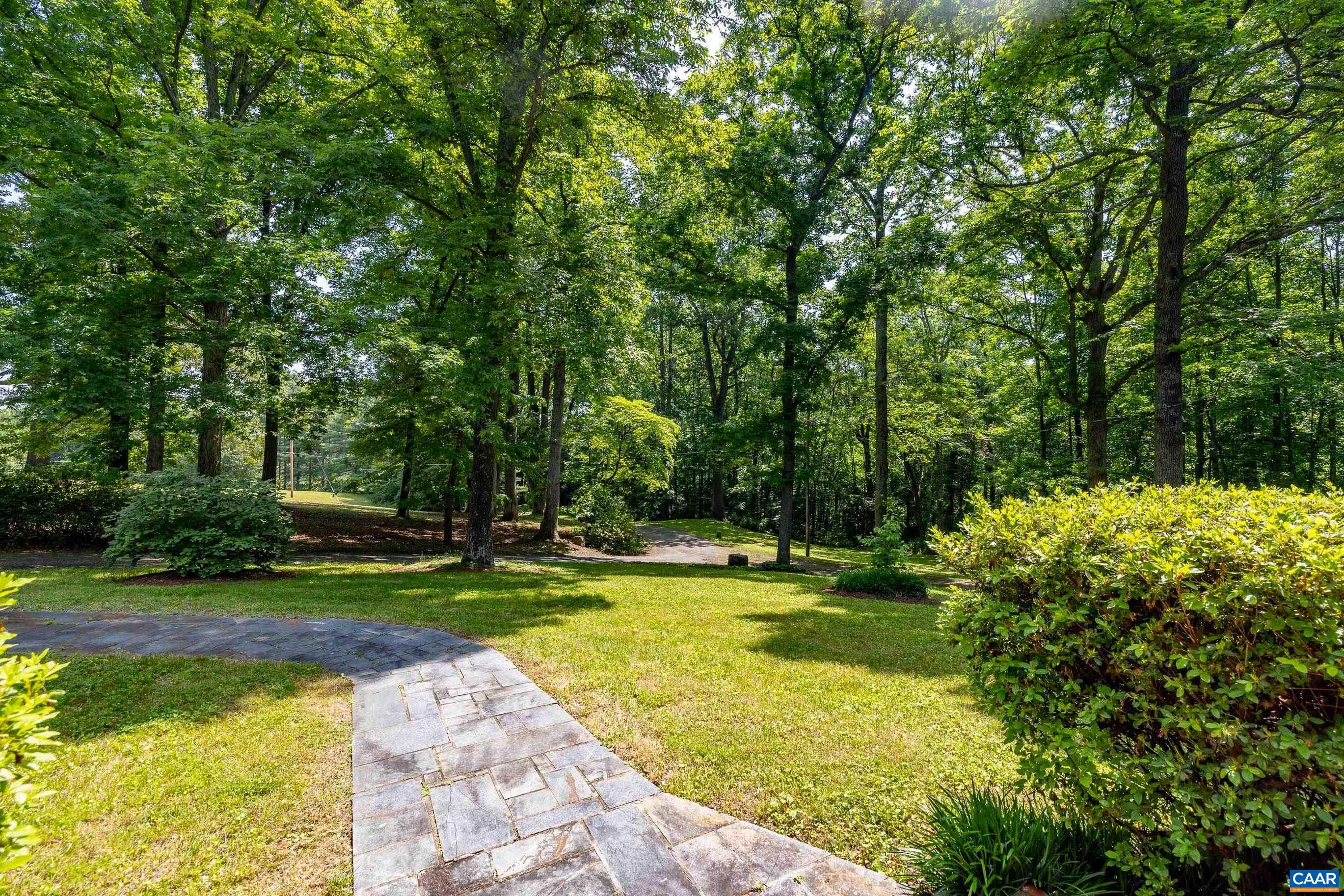 7250 Amicus Road Ruckersville, VA 22968 - Photo 19 of 74 a view of a swimming pool with a big yard and large trees