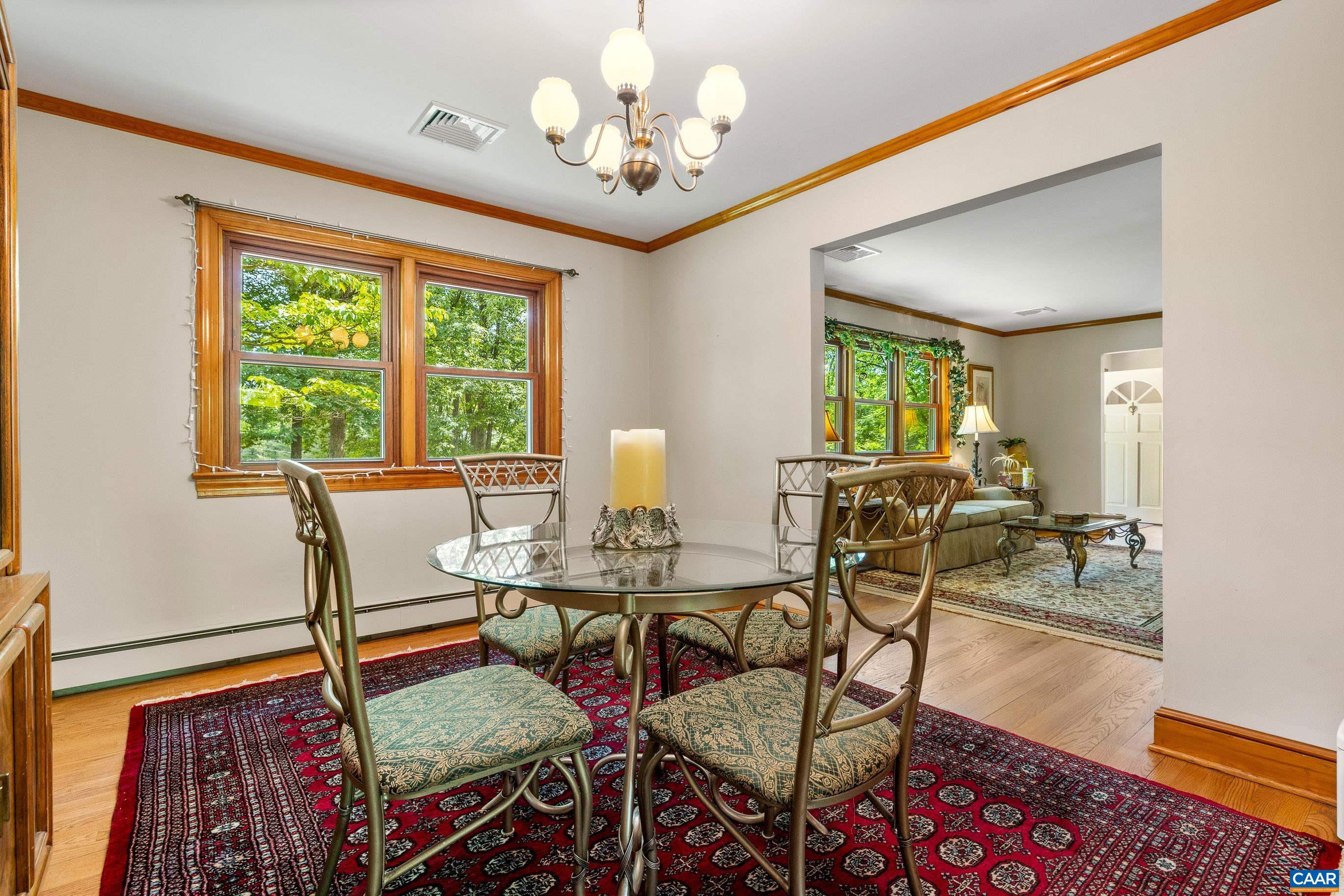 7250 Amicus Road Ruckersville, VA 22968 - Photo 28 of 74 a view of a dining room with furniture a chandelier and wooden floor