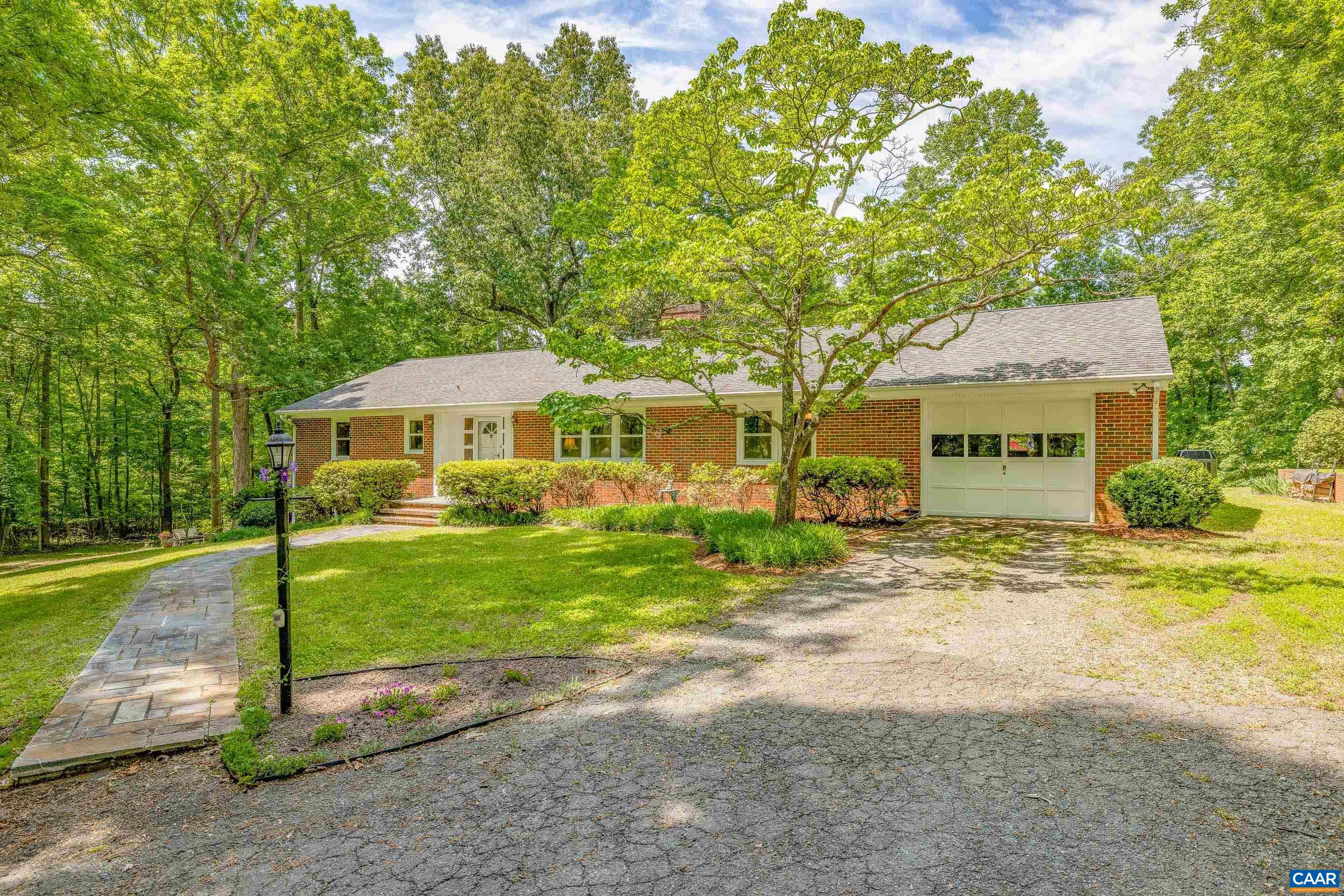 7250 Amicus Road Ruckersville, VA 22968 - Photo 3 of 74 a front view of a house with a garden