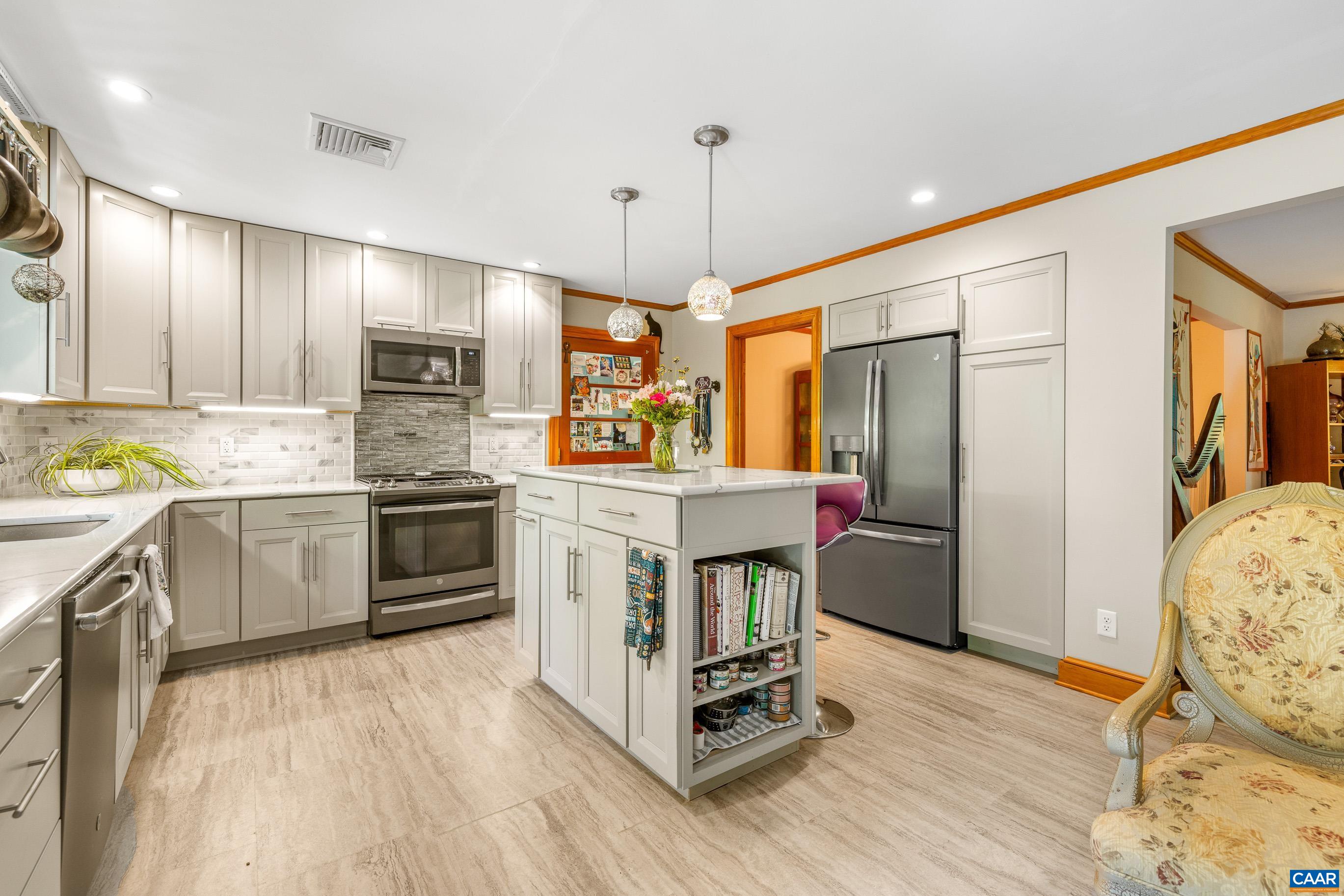 7250 Amicus Road Ruckersville, VA 22968 - Photo 35 of 74 a kitchen with stainless steel appliances a stove a refrigerator and a sink