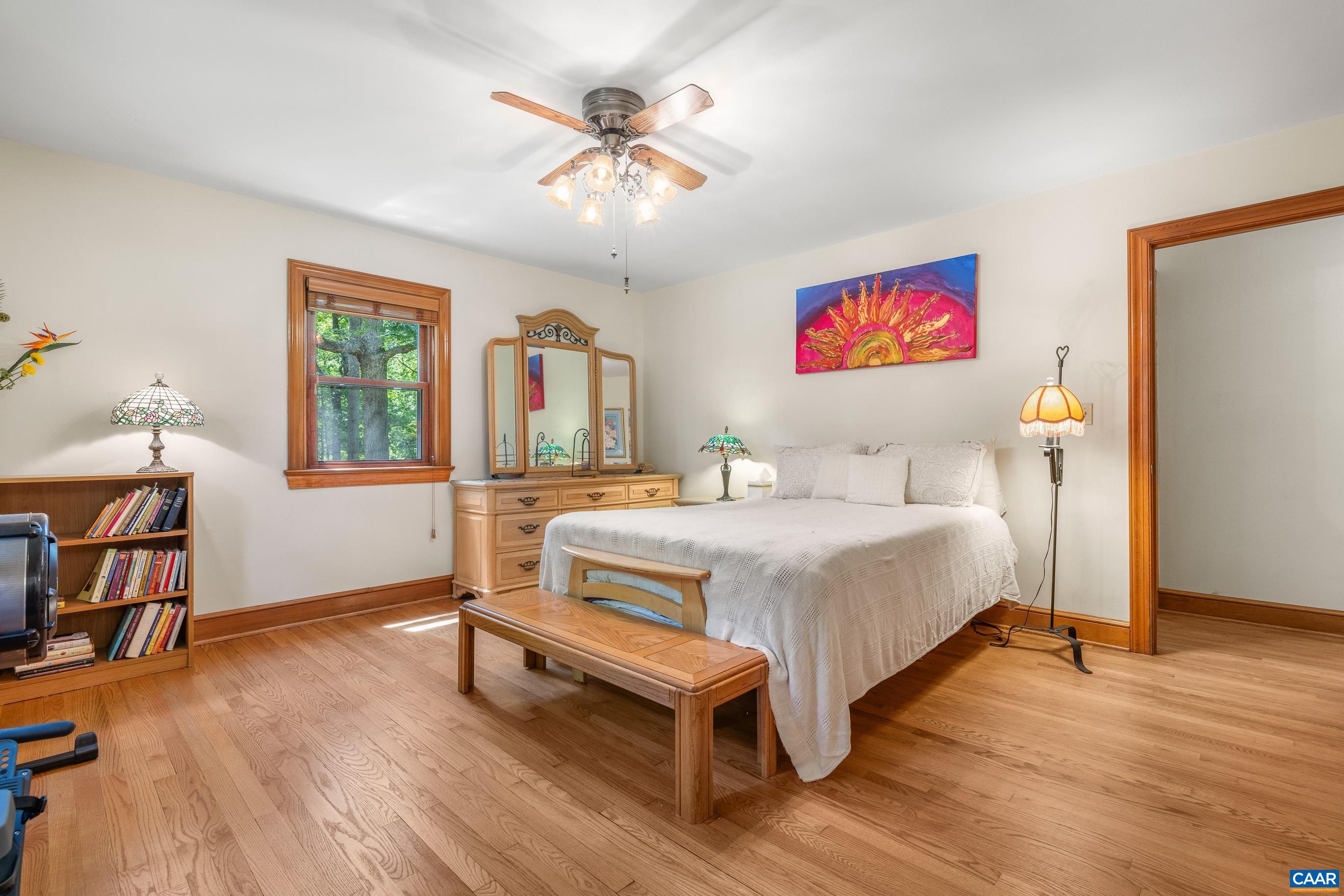 7250 Amicus Road Ruckersville, VA 22968 - Photo 46 of 74 a bedroom with a bed and a chandelier