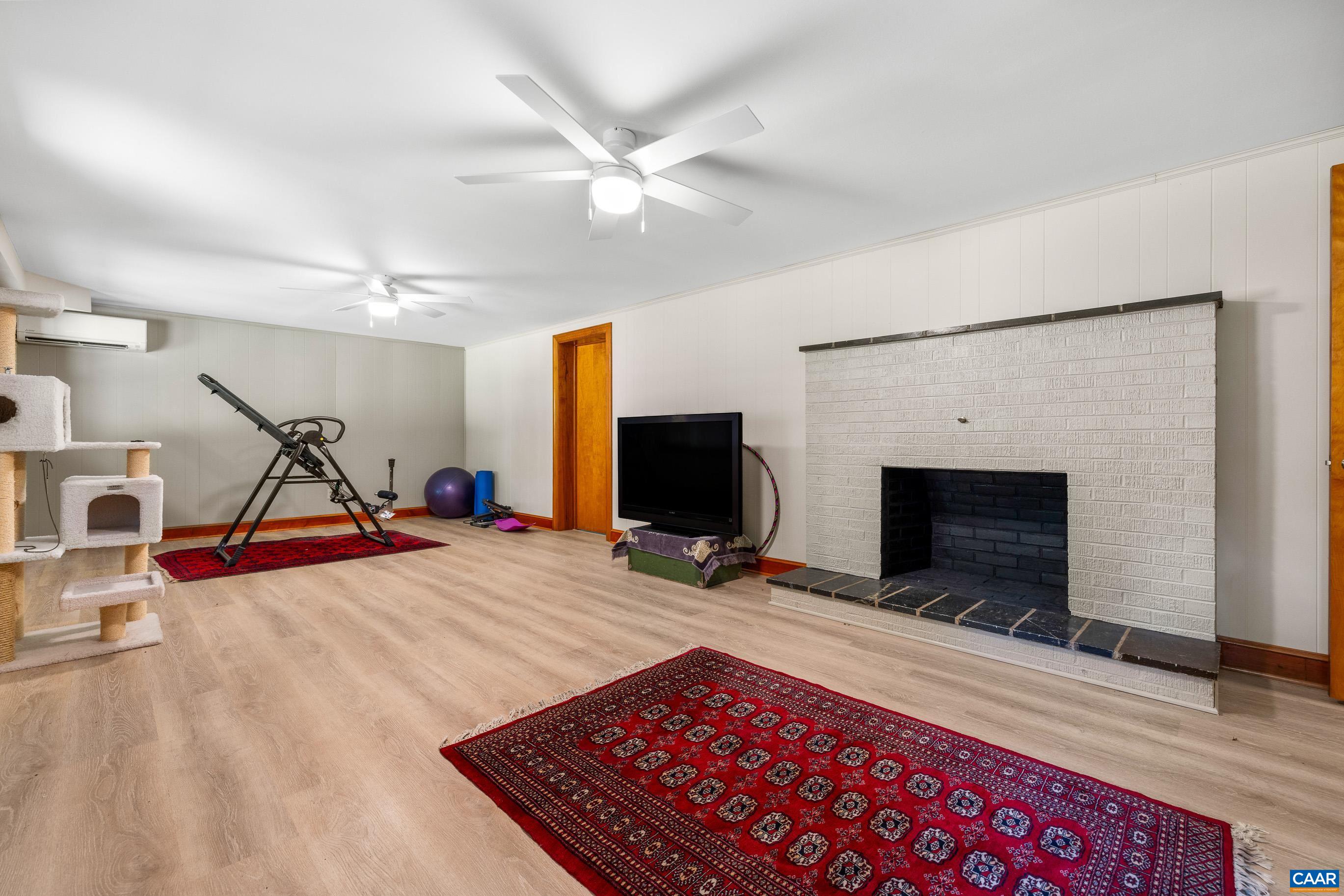 7250 Amicus Road Ruckersville, VA 22968 - Photo 50 of 74 a view of a livingroom with wooden floor and a fireplace