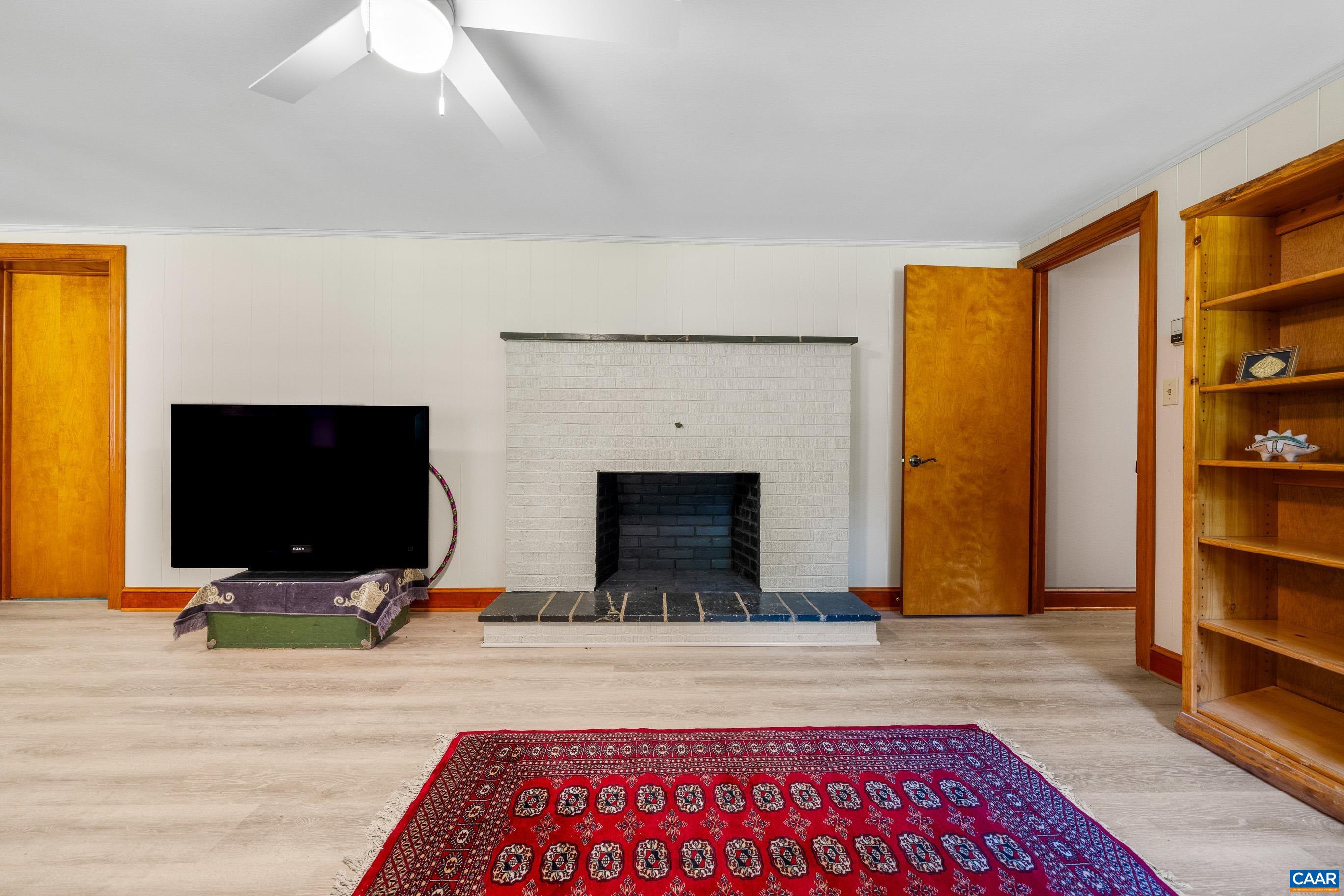 7250 Amicus Road Ruckersville, VA 22968 - Photo 51 of 74 a living room with furniture and a flat screen tv