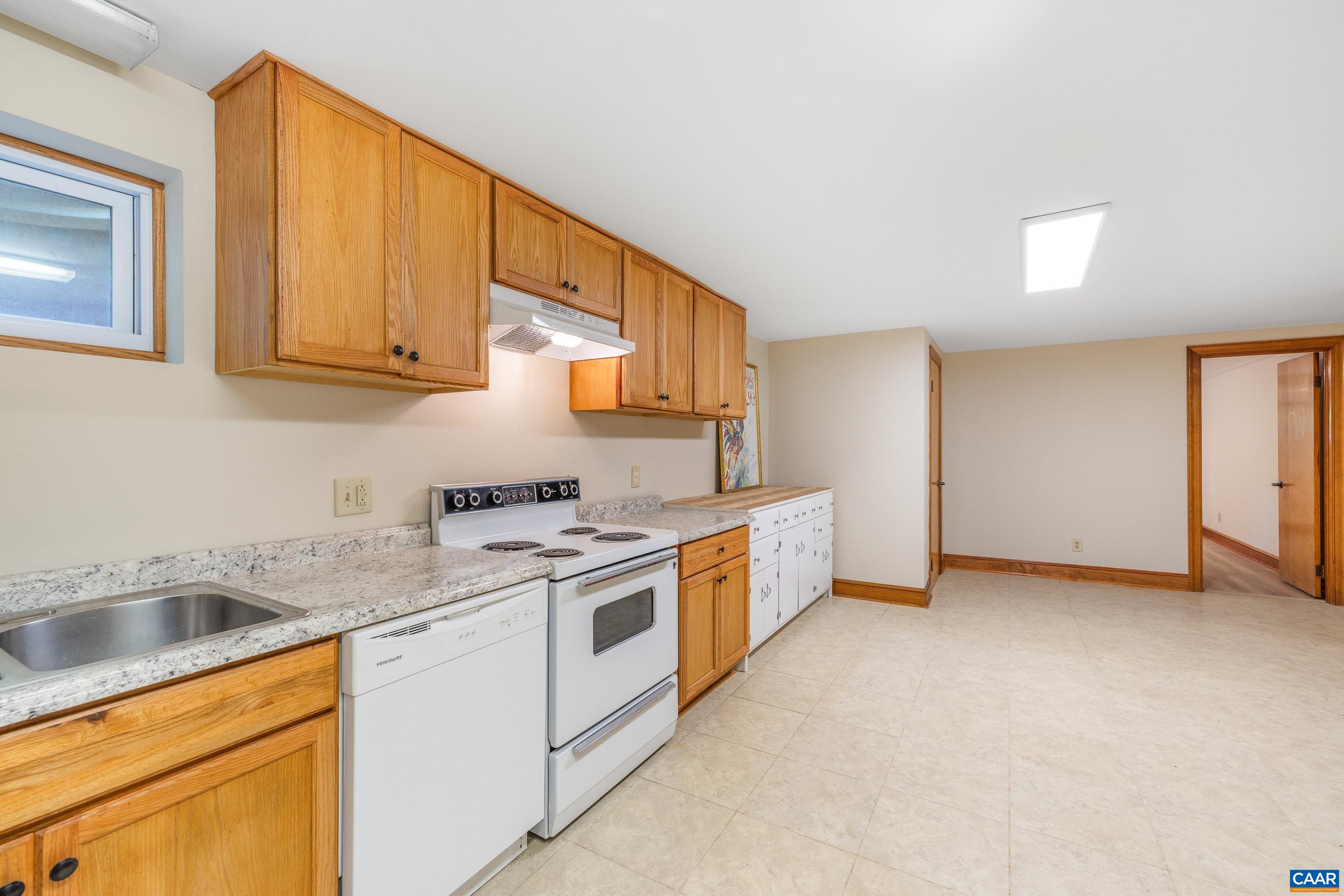 7250 Amicus Road Ruckersville, VA 22968 - Photo 54 of 74 a kitchen with stainless steel appliances granite countertop a sink and a stove top oven