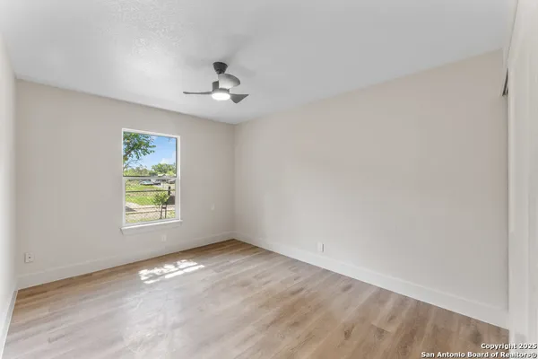 wooden floor in an empty room with a window