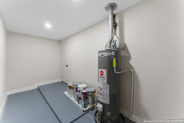 a room with water heater and wooden floor