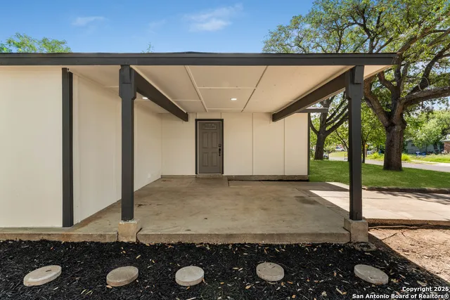 a view of a wooden door and a yard
