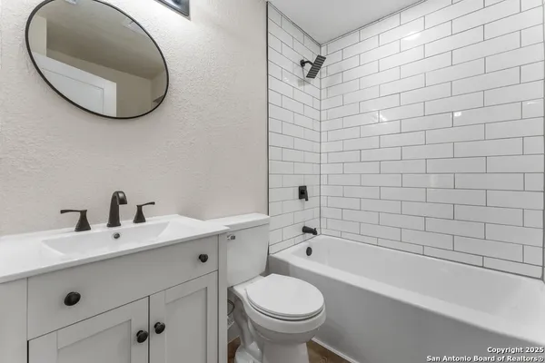 a bathroom with a sink a toilet and bathtub
