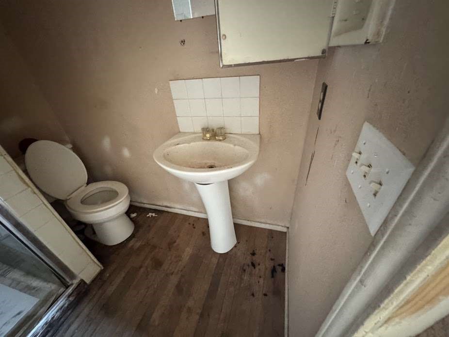 2014 Kokomo Street Plainview, TX 79072 - Photo 8 of 9 a bathroom with a toilet sink and mirror