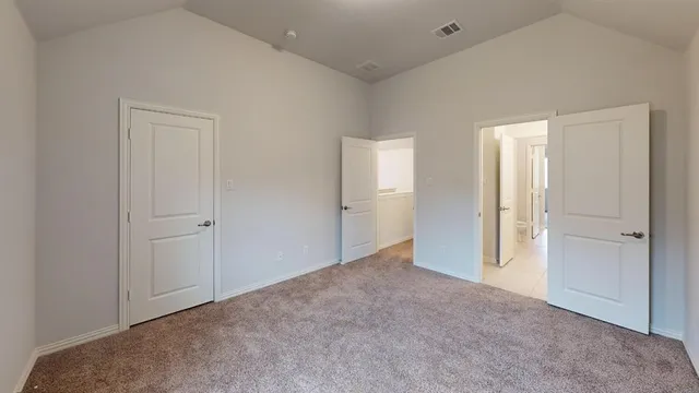 a view of an empty room and closet area