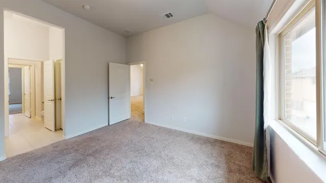 a view of an empty room and a window