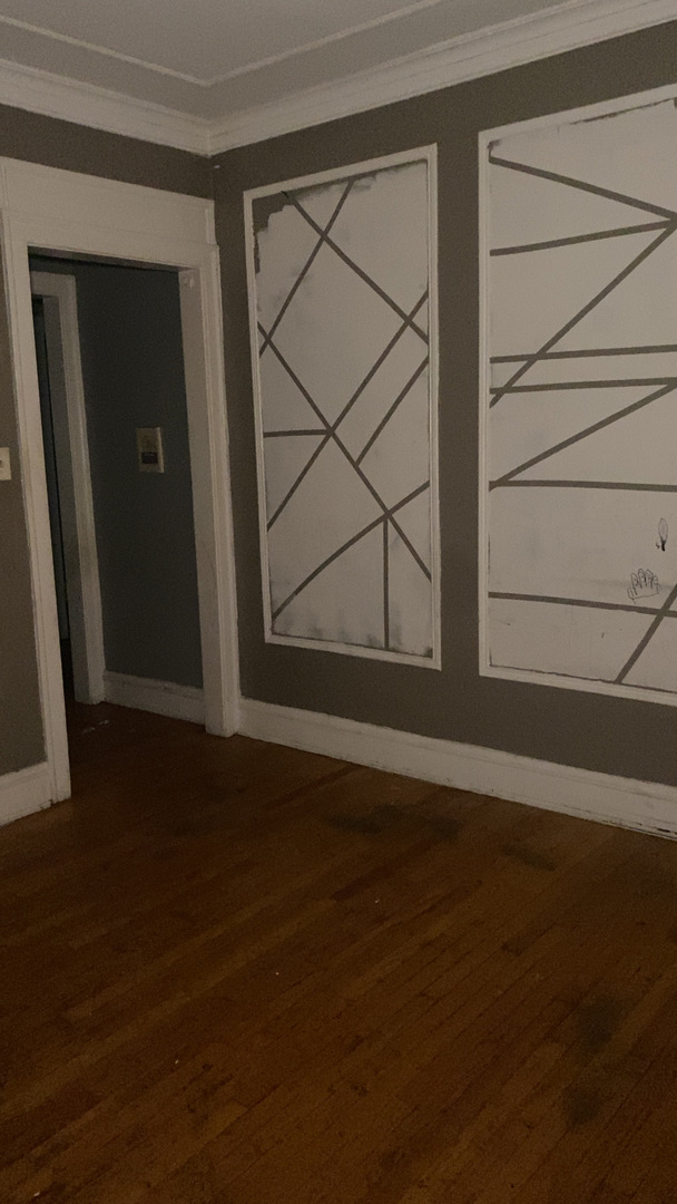 2233 East 70th Place, Unit 1 Chicago, IL 60649 - Photo 12 of 17 a view of an empty room with wooden floor and a window