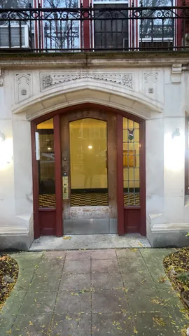 a view of kitchen with refrigerator and cabinets