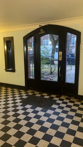 a view of a livingroom with wooden floor and a black gate
